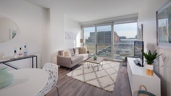 a living room with a couch and a table and a large window